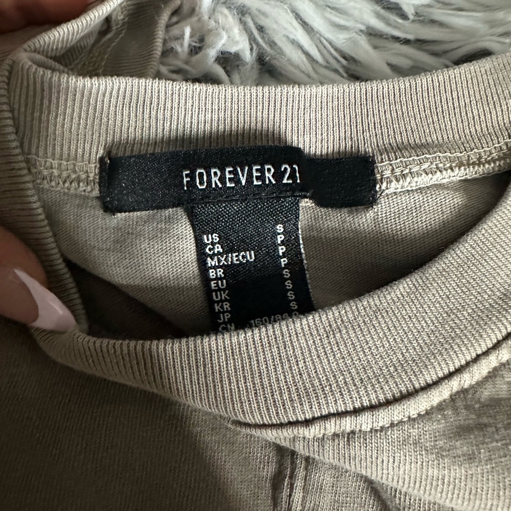 a cropped beige shirt